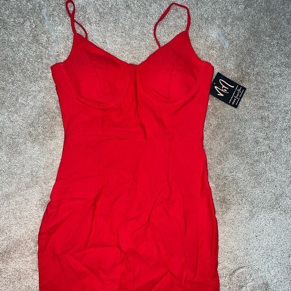 Red mini dress with tags. Size Medium. Stretchy. The Vintage Shop.